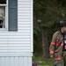 Superior Township Fire Department Capt. Shaun Bach walks by the house that caught fire. Bach said it was a heavy smoke but the firefighters were able to remove the flammable gas from the house before it caught fire. Daniel Brenner I AnnArbor.com